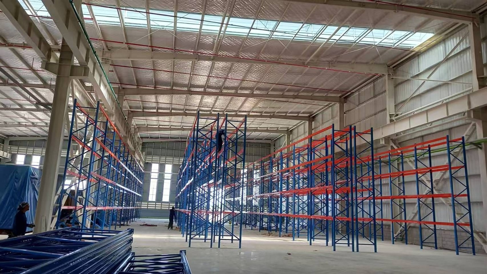 Workers installing heavy duty warehouse racking system Workers installing heavy duty warehouse racking system